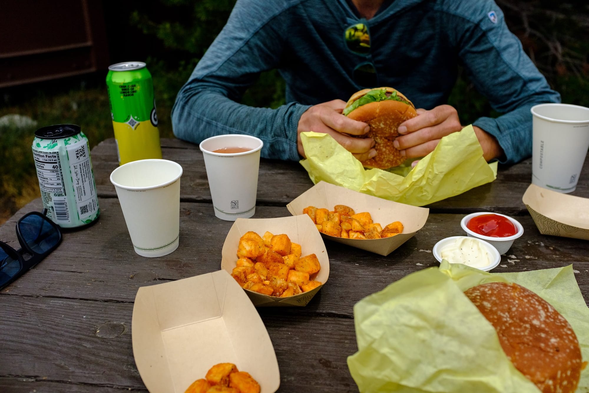 Cheeseburgers and potato wedges on a picnic table in Tuolumne Meadows