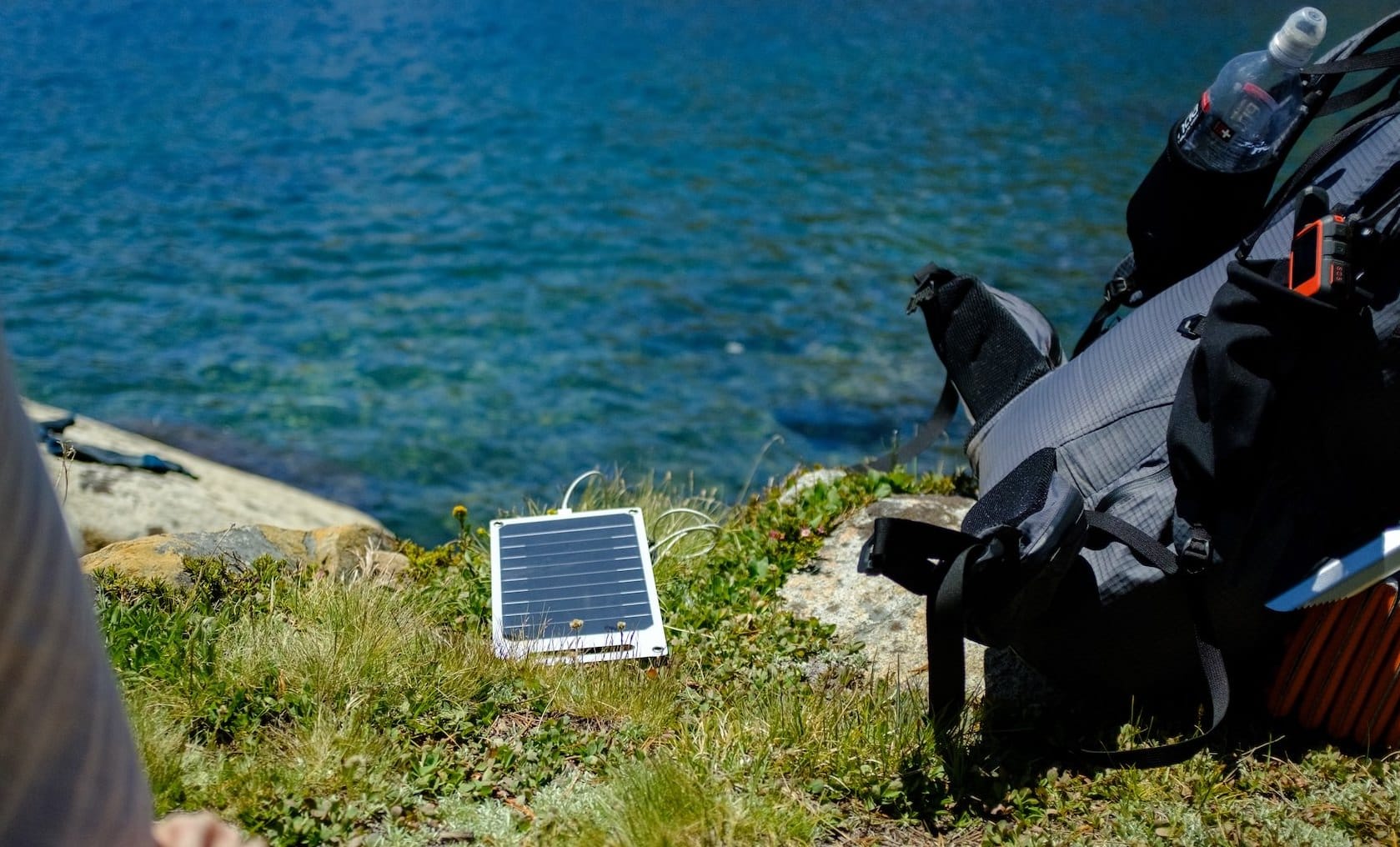 Solar panel charging Apple Watch while resting near Lake Virgina