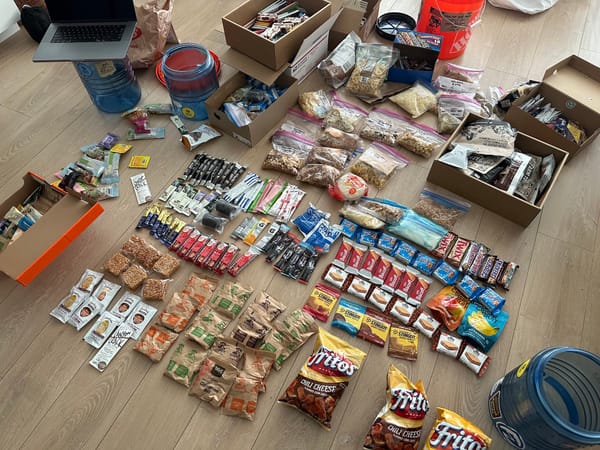 Food and snacks laid out on the floor while preparing a resupply