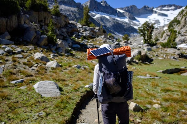 Solar panel fixed on top of backpack while hiking